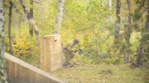 Playing paintball in the Woods Stock Footage 93330974