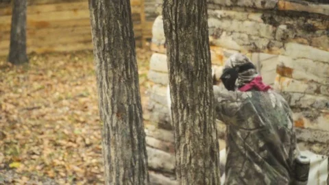 Playing paintball in the Woods Stock Footage 93332633