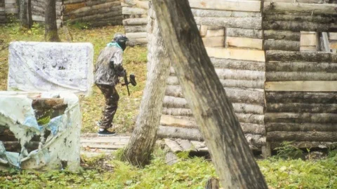 Playing paintball in the Woods Stock Footage 93333178