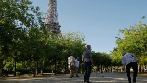 Playing Pétanque in the Parc du Champ de Mars in front of the Eiffel Tower Stock Footage 95864862