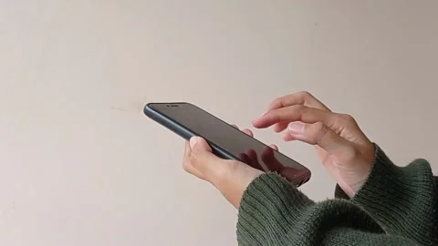 Playing the phone with a dark screen Stock Footage 150599277