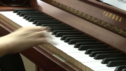Playing piano and study from notes Stock Footage 86865657