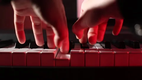 Playing piano close up , red studio color Stock Footage 242804967