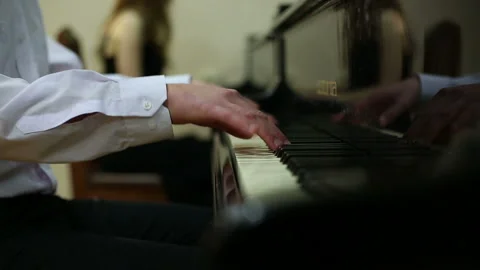 Playing the piano in four hands Stock Footage 152777894