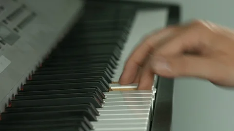 Playing on piano keyboard Stockbeeldmateriaal 107385983