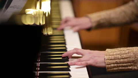 Playing the piano. The musician performs the composition. Hands visible close up Video stock 182368899