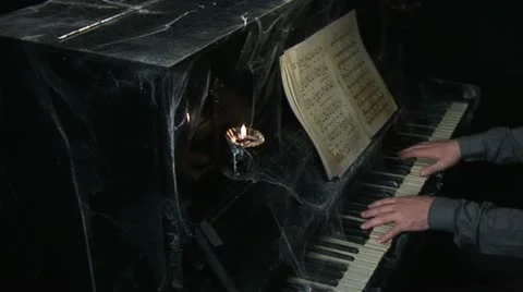 Playing the piano tangled with cobwebs Video stock 12715805