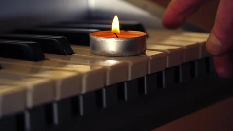 Playing piano with tealight candle Stock Footage 293494594