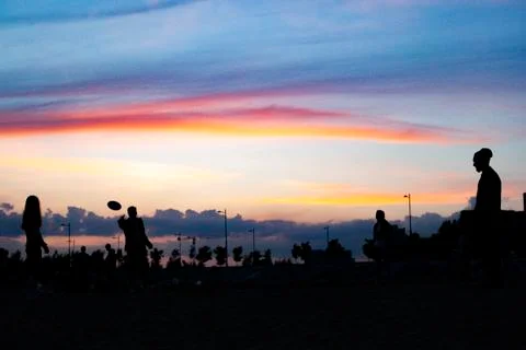 Playing with a plate at sunset 스톡 사진