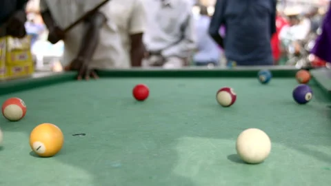 Playing pool in uganda africa hitting the ball Stock Footage 170867929