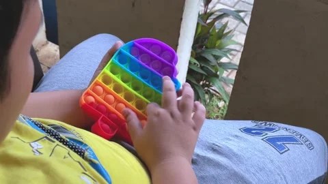 Playing pop it touching or pressing bubble. young boy playing pop it toys. 4k 스톡 동영상 155760966