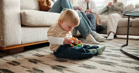 Playing, problem solving and toy with baby boy in home living room for motor Stock Footage 341427838