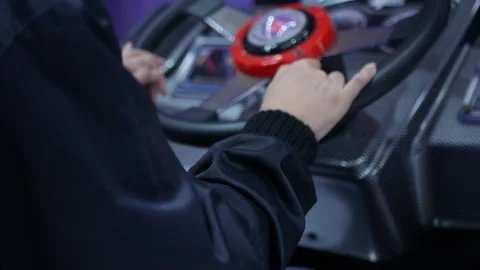 Playing a racing car game machine at arcade. Stock Footage 306315450