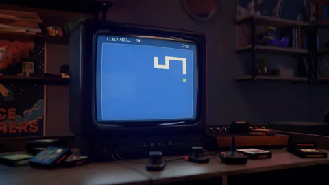 Playing the retro console game on the old-school tv set in the gaming room Stock Footage 233661412