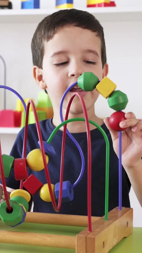 Playing with roller coaster maze toy skill Stockbeeldmateriaal 333908707