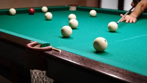 Playing Russian billiards on a green table. The professional player hits th.. Stock Photos