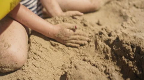 Playing with Sand and Waves on The Beach on a Summer Day Stock-Footage 60381404