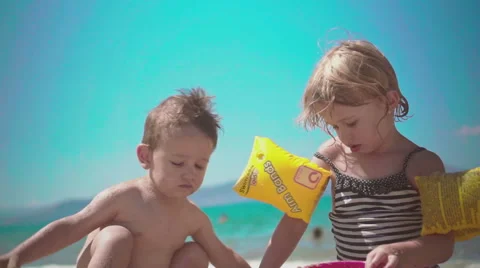 Playing with Sand and Waves on The Beach on a Summer Day Video stock 60381769