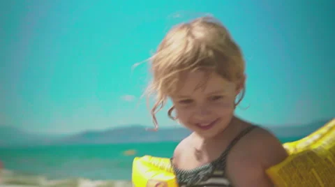 Playing with Sand and Waves on The Beach on a Summer Day Stock Footage 60382602