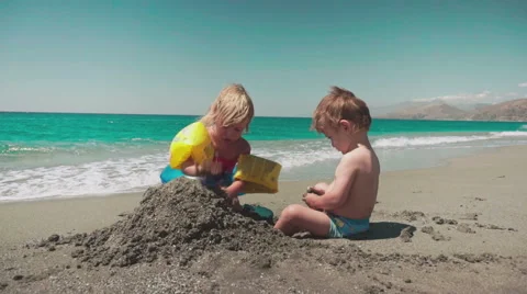 Playing with Sand and Waves on The Beach on a Summer Day Stock Footage 60383265