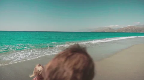 Playing with Sand and Waves on The Beach on a Summer Day Видео 60383350