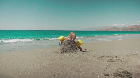 Playing with Sand and Waves on The Beach on a Summer Day Stock Footage 60383422