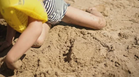 Playing with Sand and Waves on The Beach on a Summer Day Stock Footage 60383601