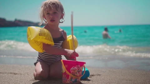 Playing with Sand and Waves on The Beach on a Summer Day Stock Footage 60383701