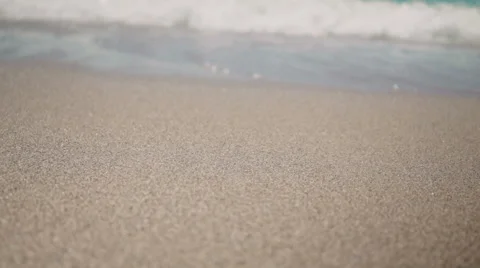 Playing with Sand and Waves on The Beach on a Summer Day Stock Footage 60384162