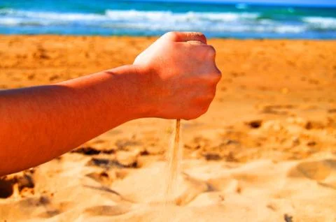 Playing with sand in the beach Stock Photos