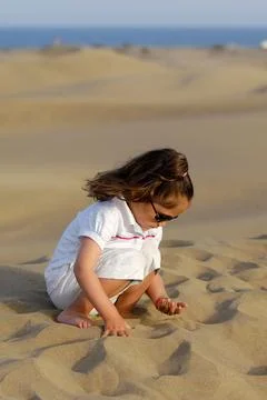 Playing with sand Stock Photos