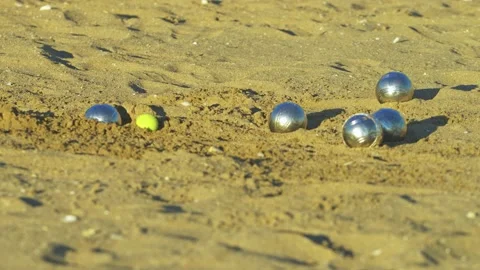 Playing on the sandy beach with petanque balls Stock Footage 239544713