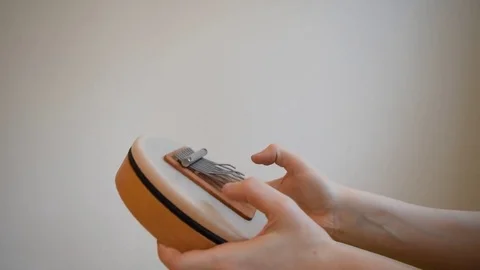 Playing the sansula Stock Footage 72960511