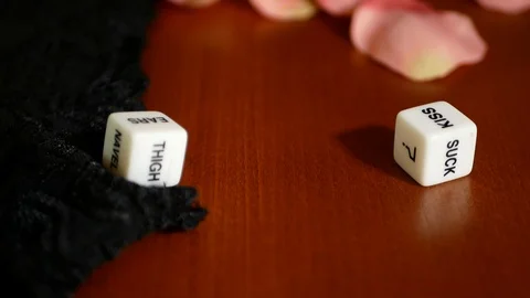 Playing sexual games with cubes. Cubes, panties and some pink rose petals. Stock Footage 121968996