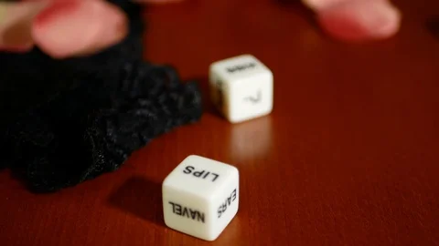 Playing sexual games with cubes. Cubes, panties and some pink rose petals. Stock Footage 121969234