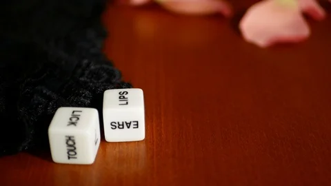 Playing sexual games with cubes. Cubes, panties and some pink rose petals. Stock Footage 121969318