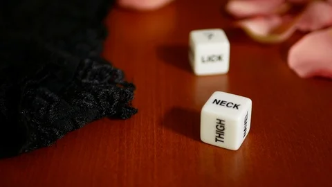 Playing sexual games with cubes. Cubes, panties and some pink rose petals. Stock Footage 121969325