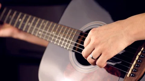 Playing a six-string guitar Stock Footage 120384956