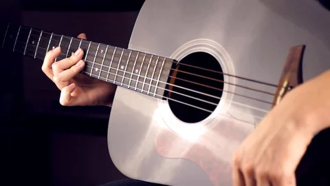 Playing a six-string guitar Stock Footage 120385089