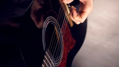 Playing a six-string guitar Stock Footage 120385130