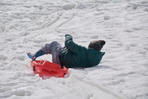 Playing with the sled in the snowy mountain Stock Photos