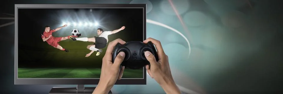 Playing soccer computer game with controller in hands Stock Photos