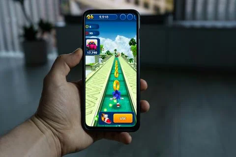 Playing Sonic dash mobile game. Point of view gaming Sonic dash game on Stock Photos