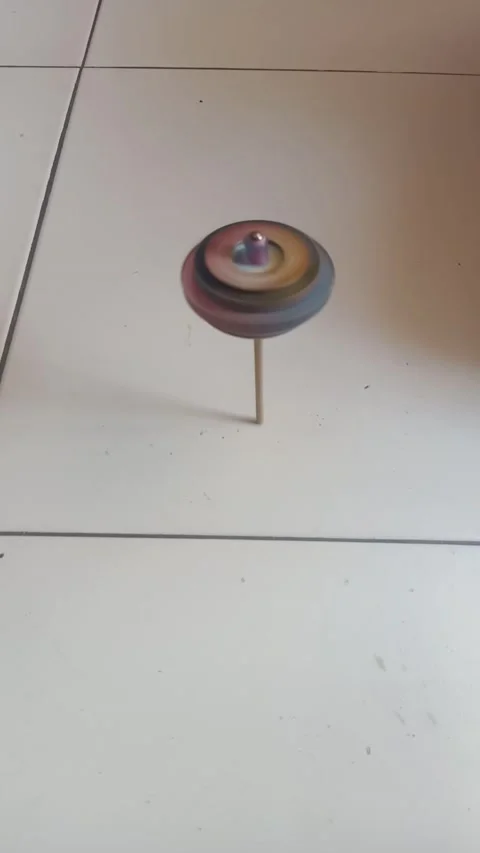 Playing the spinning top toy Stock Footage 235502199
