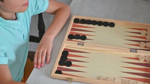 Playing a strategic game of backgammon at the table Stock Footage 290050551