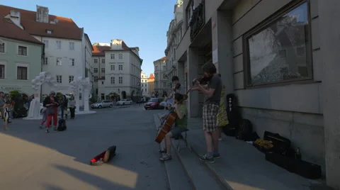 Playing string instruments in Franz Kafka Square, Prague Stock Footage 55577771