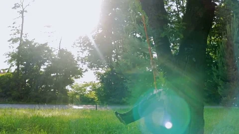 Playing on the swing at the sunset Stockbeeldmateriaal 78180780