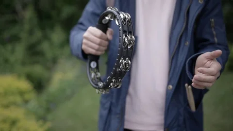 Playing on the tambourine. Stock Footage 76878857