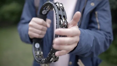 Playing on the tambourine. Stock Footage 76879027