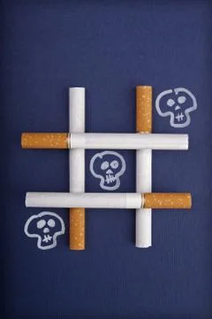 Playing tic tac toe with the death – Smoking metaphor Stock Photos